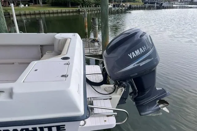 Slide: The Image of 2002 Grady-White Gulfstream 232 boat with Yamaha outboard motor docked by the water. - 8