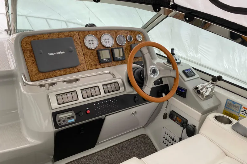 Slide: The Image of 2007 Formula 40 Performance Cruiser helm with Raymarine navigation and wood-accented steering wheel. - 4