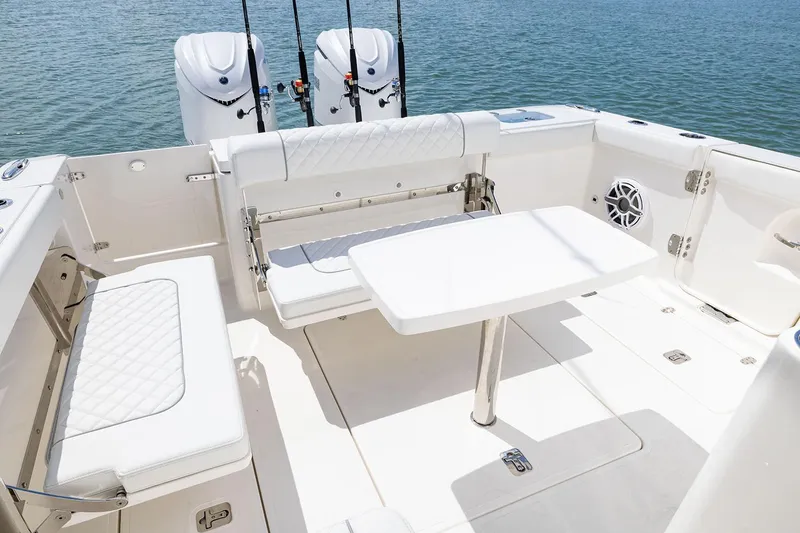 Slide: The Image of Manufacturer Provided Image: 2025 Pursuit OS 325 Offshore boat interior with seating and table. - 17