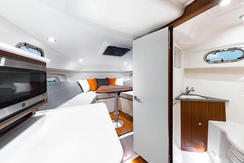 Slide: The Image of Manufacturer Provided Image: Interior of 2025 Pursuit OS 325 Offshore boat with modern amenities. - 18
