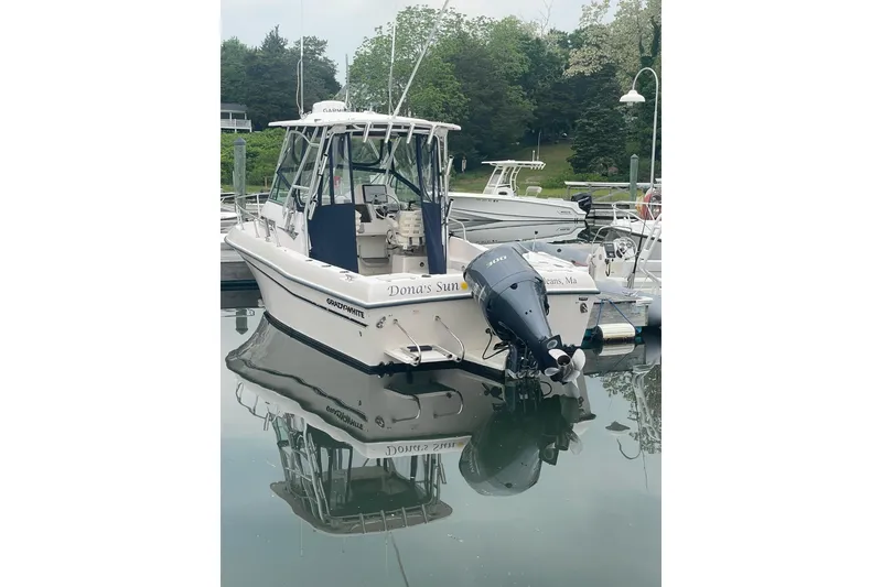 Slide: The Image of 2005 Grady-White Gulfstream 232 boat docked in calm marina waters. - 8