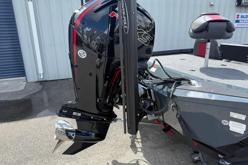 Slide: The Image of 2024 Ranger RT188P boat with a powerful outboard motor, parked outdoors. - 4
