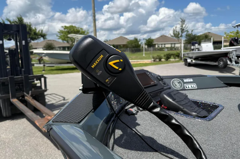 Slide: The Image of 2024 Ranger RT188P boat with Maxxum trolling motor control, outdoors under a cloudy sky. - 8