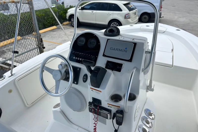 Slide: The Image of 2004 HYDRASPORT 20 boat dashboard with Garmin navigation system and steering wheel. - 4