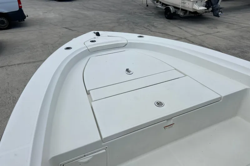 Slide: The Image of 2004 HYDRASPORT 20 boat deck with storage compartments, parked on concrete surface. - 6