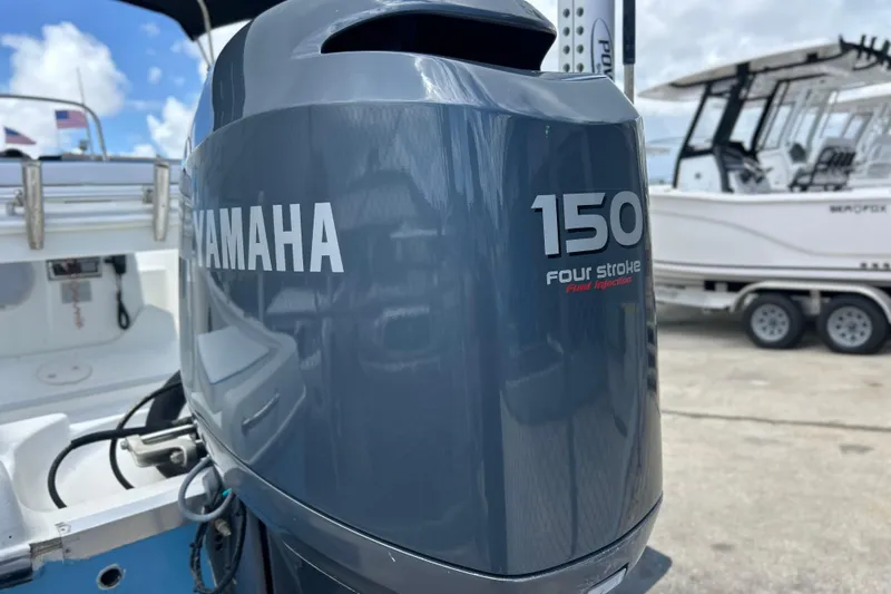 Slide: The Image of Yamaha 150 four-stroke outboard motor on 2004 HYDRASPORT 20 boat, dockside view. - 9