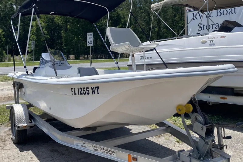 The Image of 2008 Carolina Skiff 18 JVX SC boat on trailer, parked outdoors near RV storage. - 1