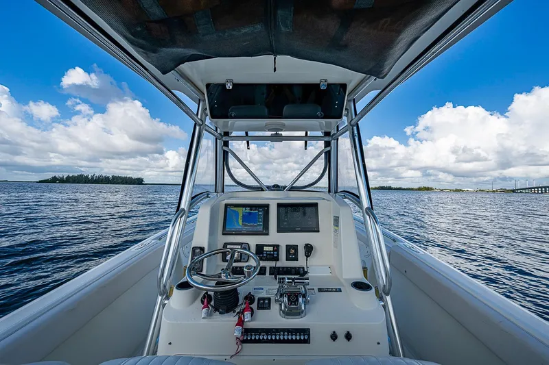 Slide: The Image of 2005 Pursuit 3480 Center Console boat dashboard with ocean view and blue sky. - 9