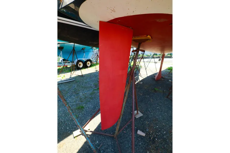Slide: The Image of Red keel of a 2008 J Boats J/100 sailboat on stands. - 21