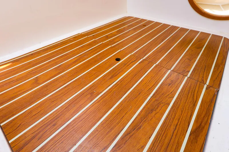 Slide: The Image of Teak deck of 2008 J Boats J/100 sailboat, featuring elegant wood grain and white stripes. - 19