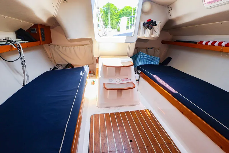 Slide: The Image of Interior of 2008 J Boats J/100 sailboat with blue cushions and wooden flooring. - 16