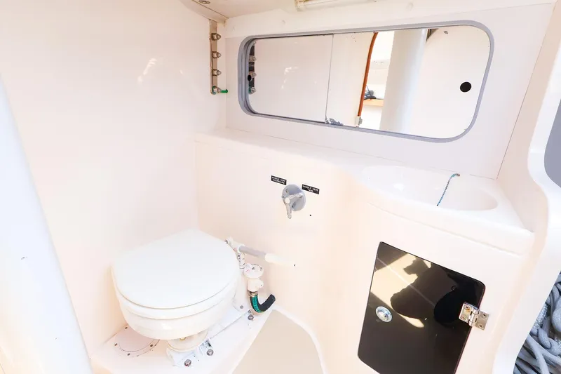 Slide: The Image of 2008 J Boats J/100 yacht bathroom with toilet, sink, and mirror. - 20