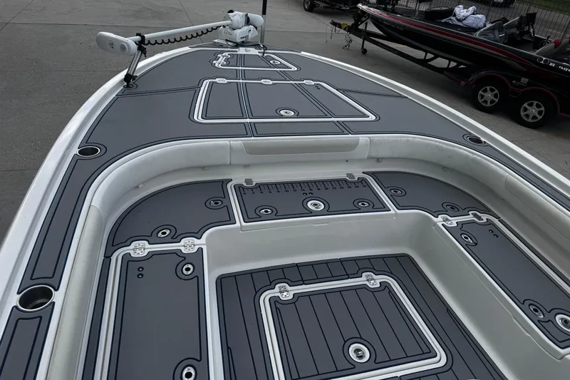 Slide: The Image of 2021 Caymas 28 HB boat deck with sleek gray design and fishing features. - 11