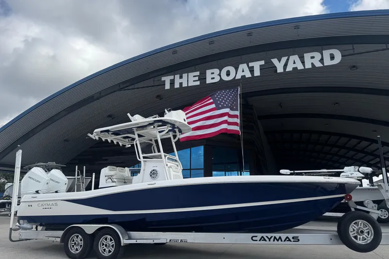 Slide: The Image of 2021 Caymas 28 HB boat on trailer at The Boat Yard, American flag displayed. - 3