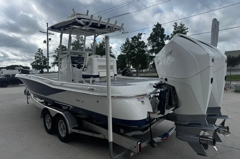 Slide: The Image of 2021 Caymas 28 HB boat with dual Mercury engines on a trailer. - 6