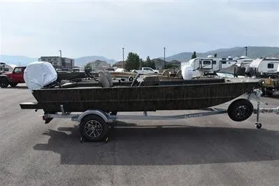 The Image of 2025 Lowe Roughneck 1860SC boat on trailer, parked outdoors with mountains in background. - 0