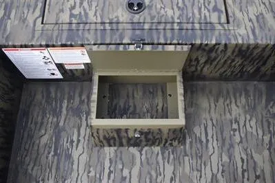 Slide: The Image of 2025 Lowe Roughneck 1860SC boat storage compartment with camouflage pattern. - 12