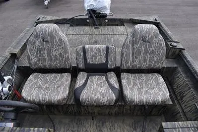 Slide: The Image of 2025 Lowe Roughneck 1860SC boat interior with camo-patterned seating. - 14
