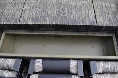 Slide: The Image of 2025 Lowe Roughneck 1860SC boat interior with storage compartment and camo seating. - 15