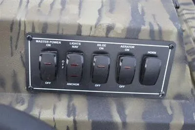 Slide: The Image of Control panel of 2025 Lowe Roughneck 1860SC boat with switches for power, lights, bilge, aerator, and horn. - 17