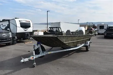 Slide: The Image of 2025 Lowe Roughneck 1860SC boat on trailer in parking lot with RVs. - 2