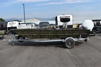 Slide: The Image of 2025 Lowe Roughneck 1860SC boat on trailer, parked outdoors with clear sky background. - 3