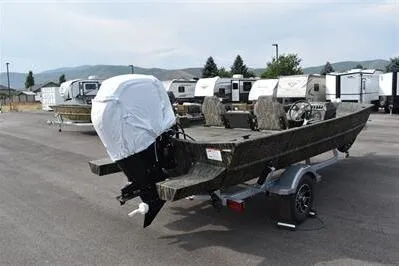 Slide: The Image of 2025 Lowe Roughneck 1860SC boat on trailer in outdoor lot, surrounded by RVs. - 5