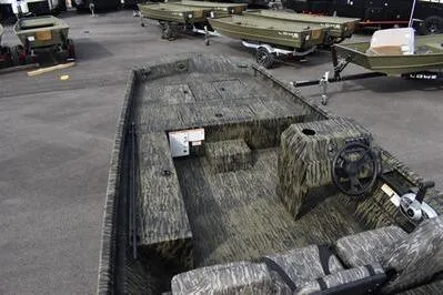 Slide: The Image of 2025 Lowe Roughneck 1860SC boat with camouflage design on display. - 6
