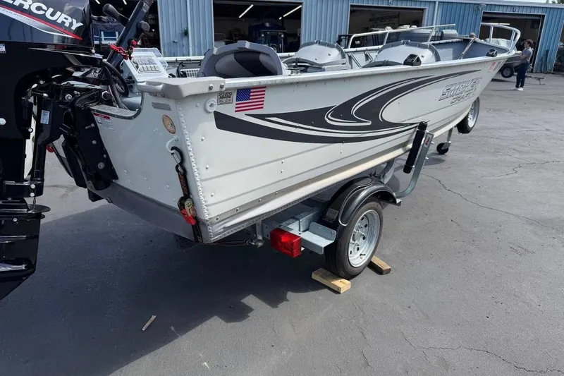 Slide: The Image of 2023 Smoker Craft Alaskan 15 boat on trailer, featuring sleek design and Mercury outboard motor. - 3