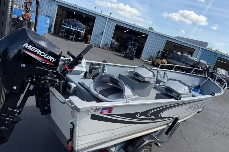Slide: The Image of 2023 Smoker Craft Alaskan 15 boat with Mercury engine at a marina. - 4