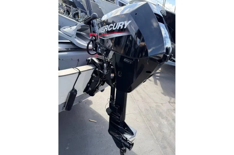 Slide: The Image of 2023 Smoker Craft Alaskan 15 with Mercury outboard motor, parked on a sunny day. - 6