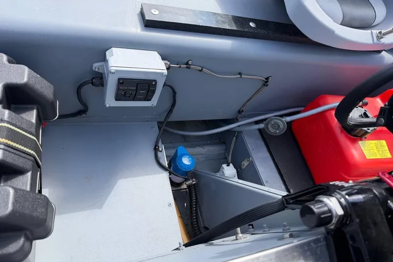 Slide: The Image of Interior view of 2023 Smoker Craft Alaskan 15 boat, featuring control panel and seating. - 7