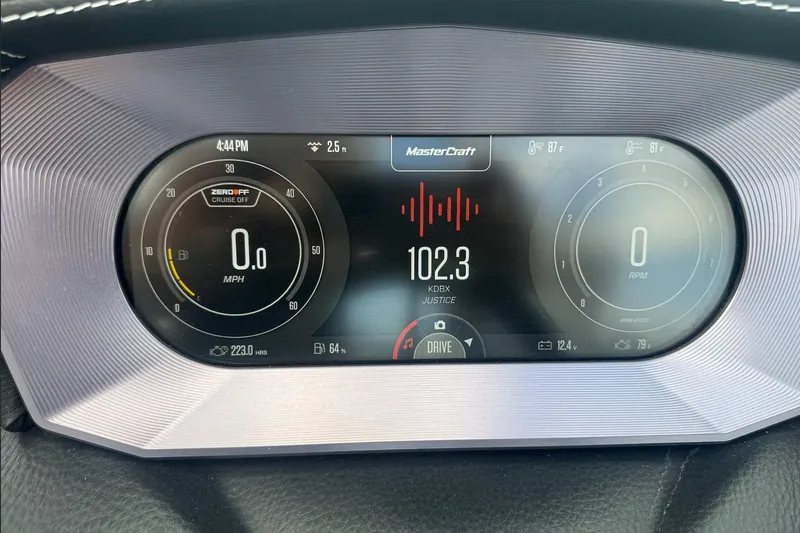Slide: The Image of Dashboard of 2023 MasterCraft XT24 displaying speed, RPM, and radio station. - 12