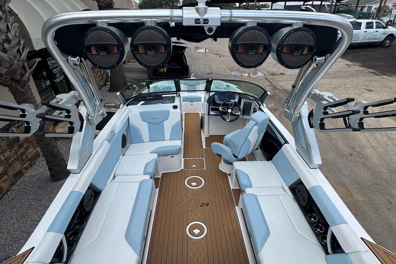 Slide: The Image of 2023 MasterCraft XT24 boat interior with luxury seating and advanced audio system. - 8