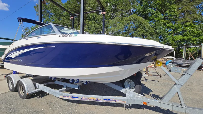 Slide: The Image of 2018 Chaparral 224 Sunesta boat on trailer, parked outdoors. - 1