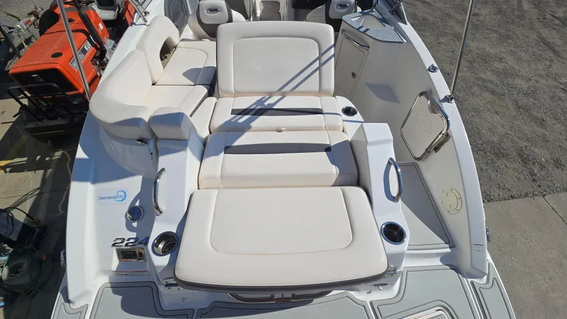 Slide: The Image of 2018 Chaparral 224 Sunesta boat interior with white seating and cup holders. - 13