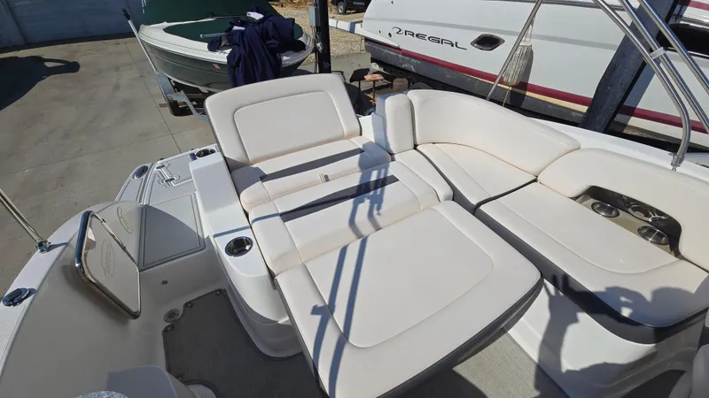 Slide: The Image of 2018 Chaparral 224 Sunesta boat interior with white seating and cup holders. - 15