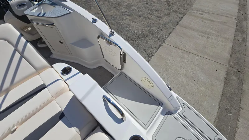 Slide: The Image of 2018 Chaparral 224 Sunesta boat interior with seating and storage compartments. - 17