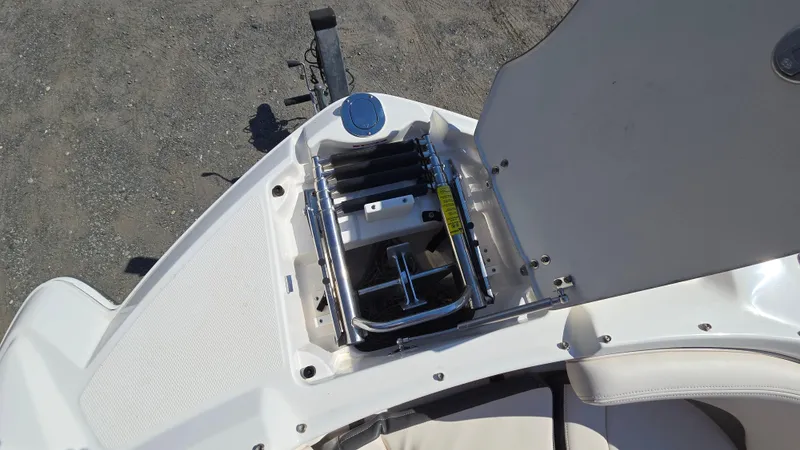 Slide: The Image of 2018 Chaparral 224 Sunesta boat with open storage compartment and ladder. - 34