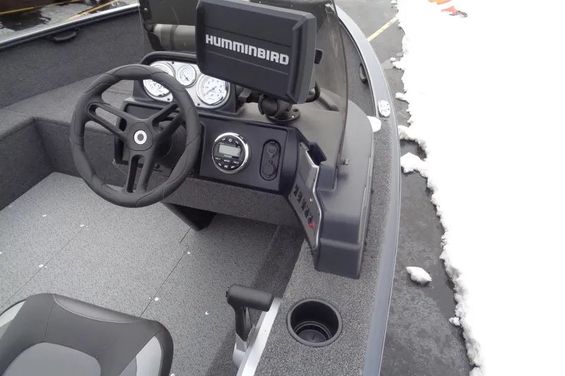 Slide: The Image of 2023 Lund 1650 Rebel XL SS boat dashboard with steering wheel and Humminbird display. - 11