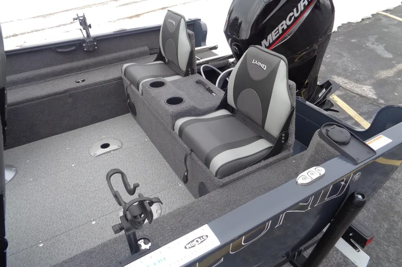 Slide: The Image of 2023 Lund 1650 Rebel XL SS boat interior with seating and Mercury engine. - 14