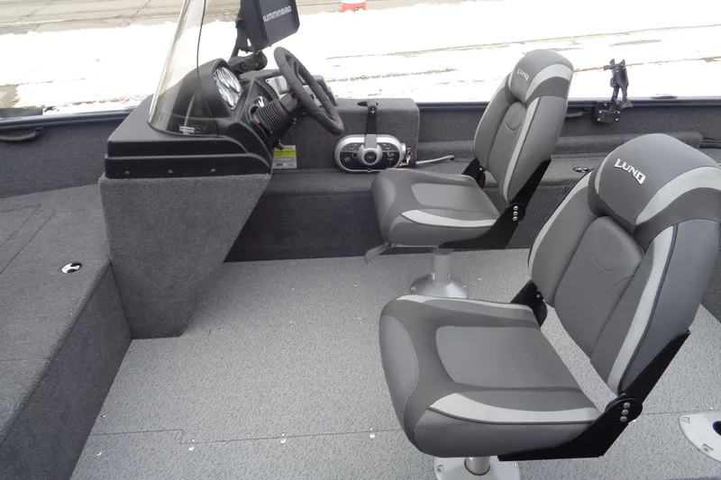 Slide: The Image of 2023 Lund 1650 Rebel XL SS boat interior with two gray seats and steering console. - 15
