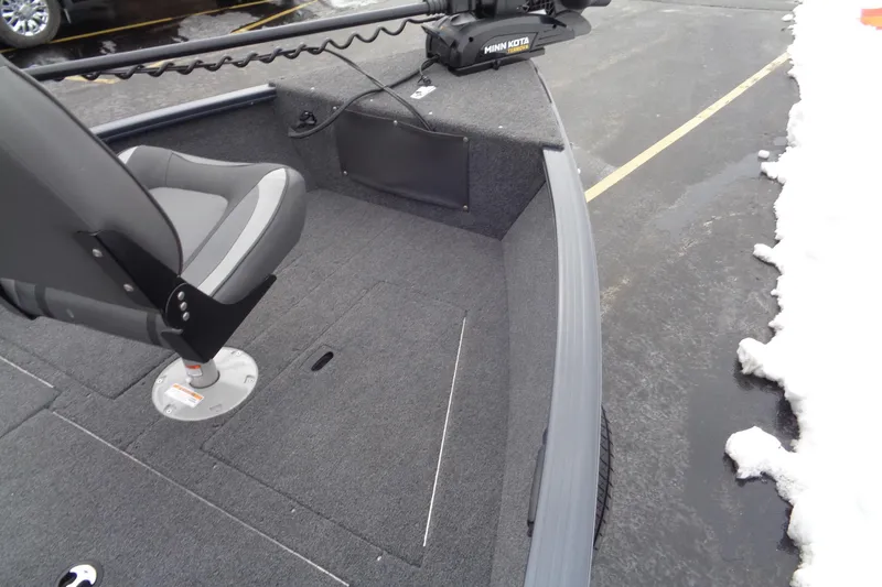 Slide: The Image of 2023 Lund 1650 Rebel XL SS boat interior with gray seating and Minn Kota trolling motor. - 16