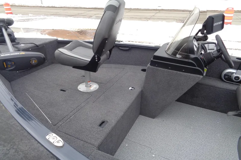 Slide: The Image of 2023 Lund 1650 Rebel XL SS boat interior with seating and steering console. - 4