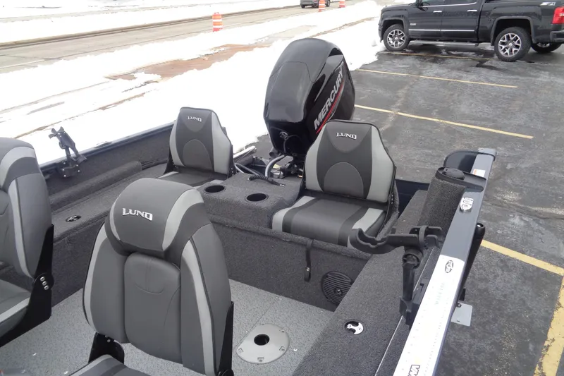 Slide: The Image of 2023 Lund 1650 Rebel XL SS boat interior with Mercury engine, parked on snowy pavement. - 8