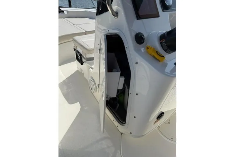 Slide: The Image of 2025 Boston Whaler 170 Montauk boat interior with open storage compartment. - 5