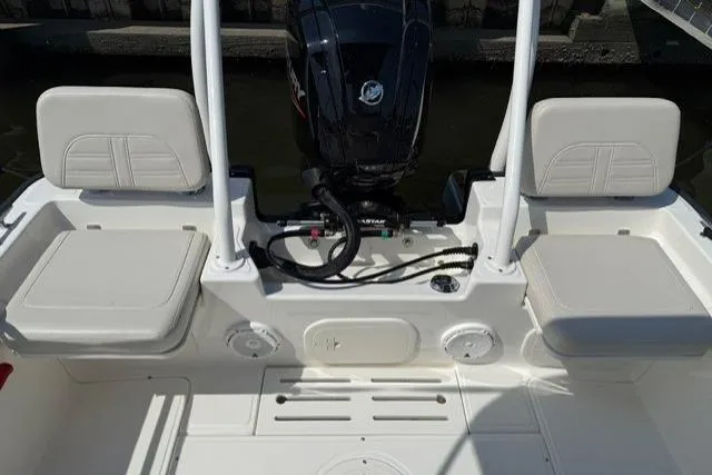 Slide: The Image of 2025 Boston Whaler 170 Montauk boat interior with seating and motor. - 9