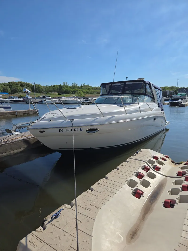 The Image of 2003 Rinker Fiesta Vee 312 boat docked in marina on sunny day. - 0