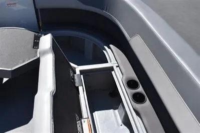 Slide: The Image of Interior view of a 2025 Lowe LS 170 boat, featuring seating and cup holders. - 20