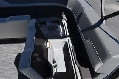 Slide: The Image of 2025 Lowe LS 170 boat interior with open storage compartment and gray seating. - 22